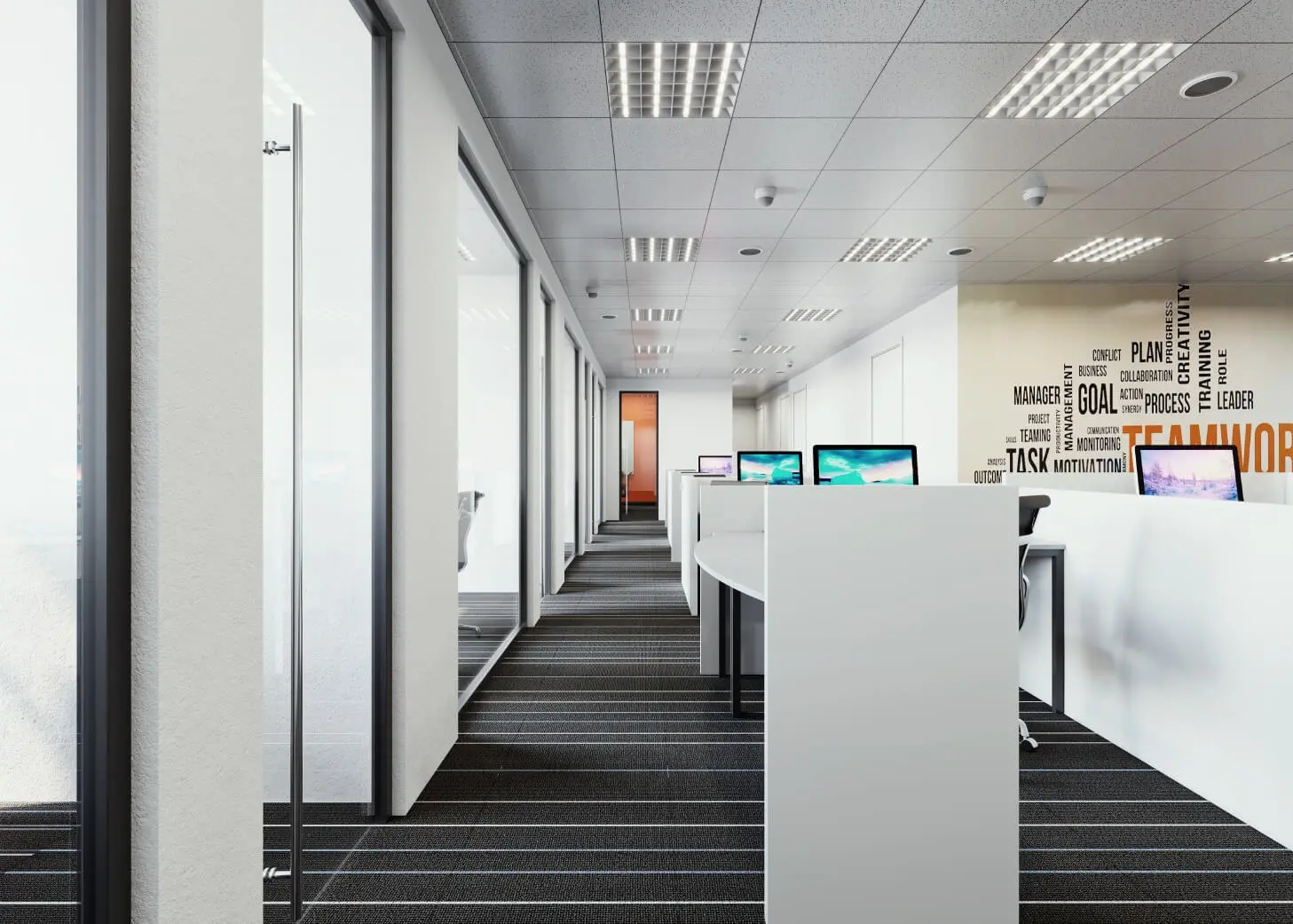 A long hallway with two desks and windows.